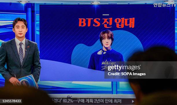 Television in Yongsan Railway Station in Seoul displays the YonhapNews TV news program flashing the portrait of Kim Seokjin or known as Jin, a member...