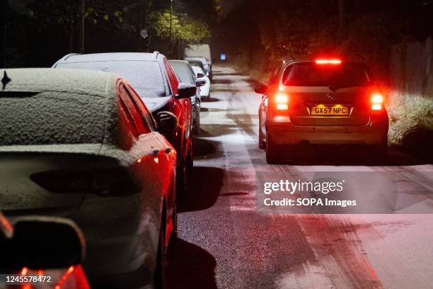 Car drives through a snow-covered road as adverse weather falls in Twickenham. Temperatures in London dropped minus three degrees Celsius last night,...