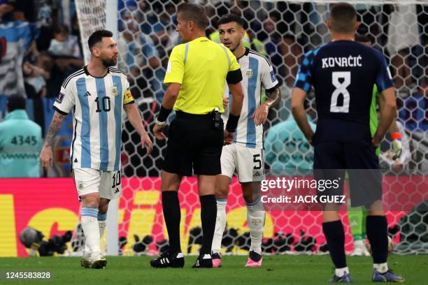 Argentina's forward Lionel Messi and Argentina's midfielder Leandro Paredes argue with Italian referee Daniele Orsato during the Qatar 2022 World Cup...