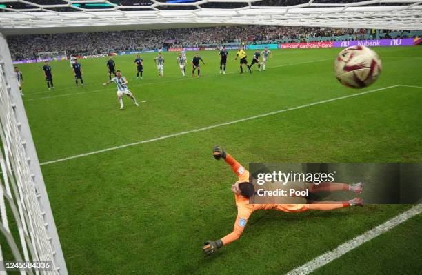 Argentina's Lionel Messi scores their first goal from the penalty spot past Croatia's Dominik Livakovic during the FIFA World Cup Qatar 2022 semi...