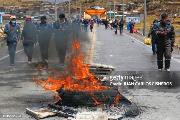 Andean peasants, supporters of former President Pedro Castillo, block the road leading to the Ilave International Bridge on the border between Peru...