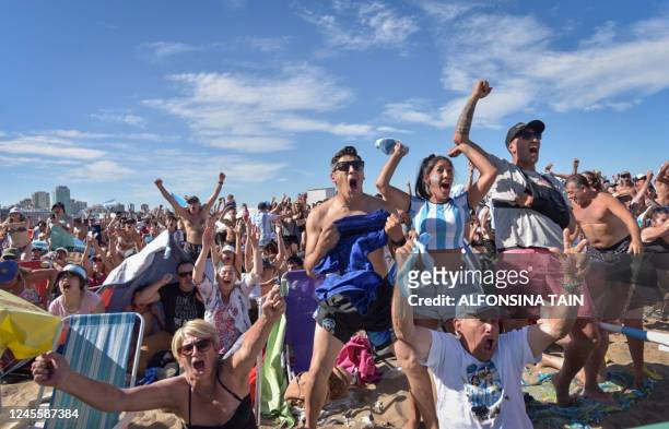 Fans of Argentina react while watching the live broadcast of the Qatar 2022 World Cup semi-final football match between Argentina and Croatia on the...