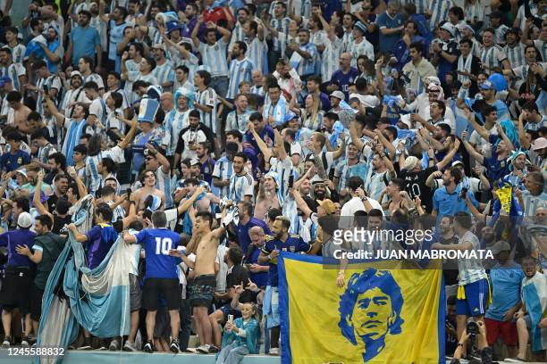 Supporters of Argentina celebrate after the team won 3-0 in the Qatar 2022 World Cup football semi-final match between Argentina and Croatia at...