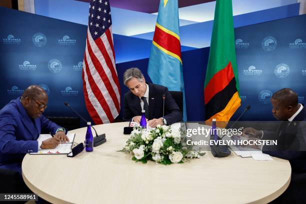 Secretary Antony Blinken , Democratic Republic of the Congo Foreign Minister Christophe Lutundula and Zambian Foreign Minister Stanley Kakubo sign a...