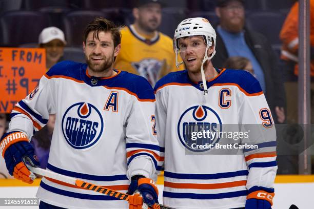 Leon Draisaitl and Connor McDavid of the Edmonton Oilers warm up before the game against the Nashville Predators at Bridgestone Arena on December 13,...