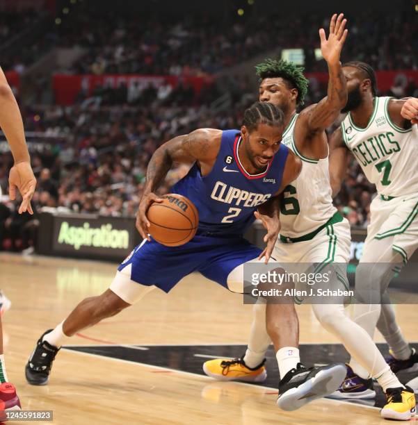 Los Angeles, CA Clippers forward Kawhi Leonard, #2, left, drives to the hoop past Celtics guard Marcus Smart in the second half at Crypto.Com Arena...
