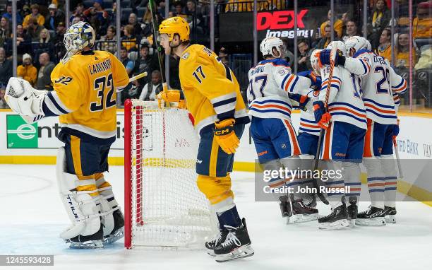 Zach Hyman of the Edmonton Oilers celebrates his goal against Kevin Lankinen and Mark Jankowski of the Nashville Predators during an NHL game at...