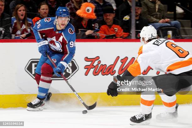 Mikko Rantanen of the Colorado Avalanche skates against Travis Sanheim of the Philadelphia Flyers at Ball Arena on December 13, 2022 in Denver,...