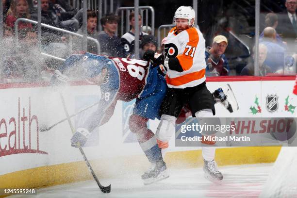 Max Willman of the Philadelphia Flyers collides with Andreas Englund of the Colorado Avalanche at Ball Arena on December 13, 2022 in Denver, Colorado.