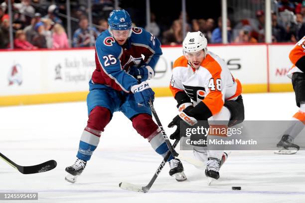 Logan O'Connor of the Colorado Avalanche skates against Morgan Frost of the Philadelphia Flyers at Ball Arena on December 13, 2022 in Denver,...