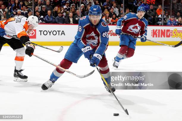 Andreas Englund of the Colorado Avalanche skates against Nicolas Deslauriers of the Philadelphia Flyers at Ball Arena on December 13, 2022 in Denver,...
