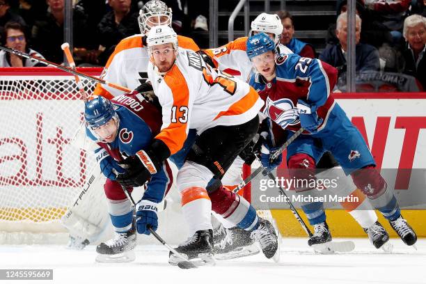 Kevin Hayes of the Philadelphia Flyers skates against Andrew Cogliano and Logan O'Connor of the Colorado Avalanche at Ball Arena on December 13, 2022...