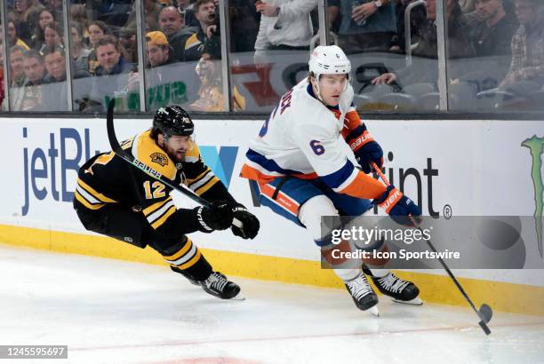 New York Islanders defenseman Ryan Pulock skates from Boston Bruins center Craig Smith during a game between the Boston Bruins and the New York...