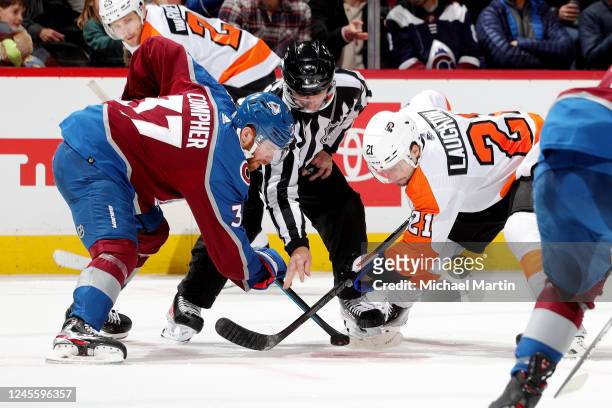 Compher of the Colorado Avalanche faces off against Scott Laughton of the Philadelphia Flyers at Ball Arena on December 13, 2022 in Denver, Colorado.