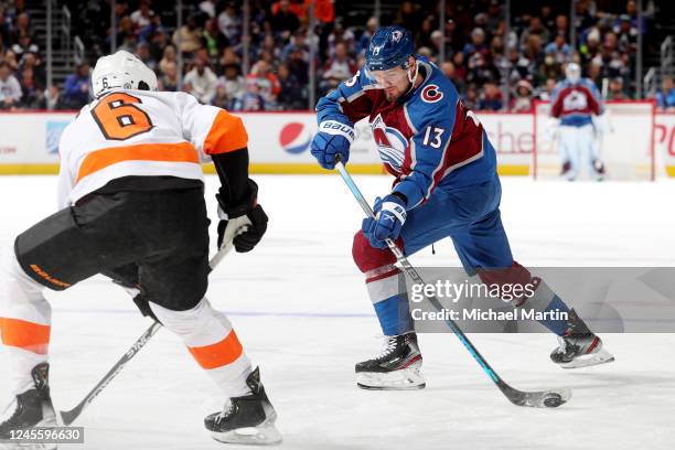 Valeri Nichushkin of the Colorado Avalanche skates against Travis Sanheim of the Philadelphia Flyers at Ball Arena on December 13, 2022 in Denver,...