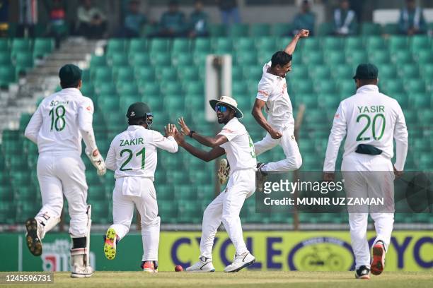 Bangladesh's Taijul Islam celebrates after the dismissal of India's Virat Kohli during the first day of the first cricket Test match between...