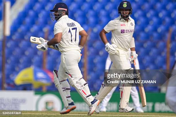 India's Rishabh Pant and Cheteshwar Pujara run between the wickets during the first day of the first cricket Test match between Bangladesh and India...