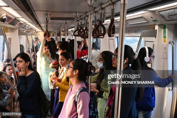 In this photograph taken on December 9 women passengers travel in a women only compartment inside the Delhi metro in New Delhi. - Ten years ago the...