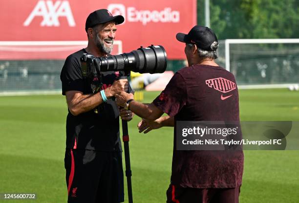 Manager Jurgen Klopp of Liverpool with photographer John Powell during a training session on December 14, 2022 in Dubai, United Arab Emirates.