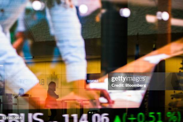 Stock price information and a projection of an advertisement displayed in the lobby of the Euronext NV stock exchange in Paris, France, on Wednesday,...