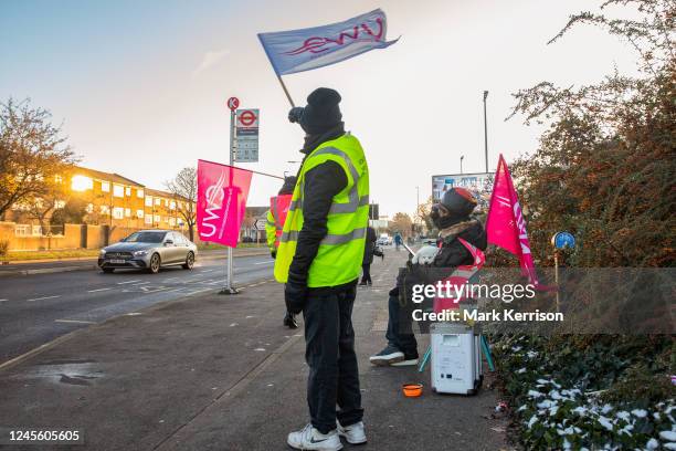 Royal Mail workers from the Communication Workers Union wave flags to passing motorists showing support for their industrial action on 14 December...