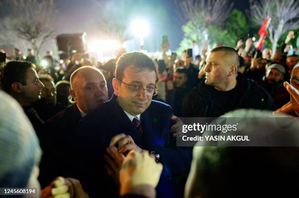 Istanbul Mayor Ekrem Imamoglu joins his supporters as they gather in front of Istanbul Metropolitan Municipality during a protest in Istanbul on...