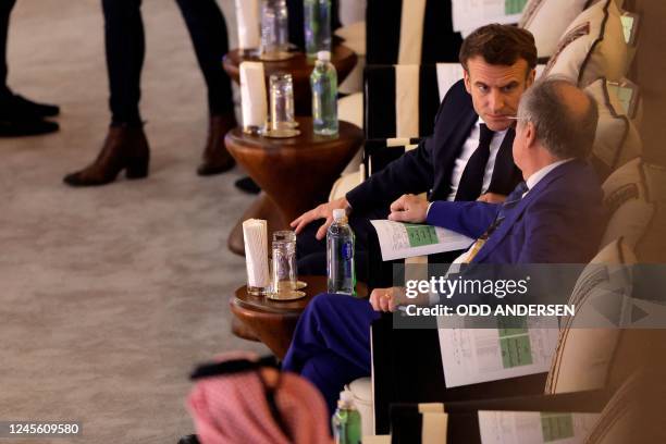 French President Emmanuel Macron speaks with the president of the French Football Federation, Noel Le Graet, as they attend the Qatar 2022 World Cup...