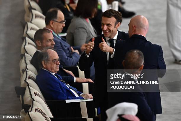 French President Emmanuel Macron gives thumbs-up as he attends with FIFA President Gianni Infantino and French Football Federation President Noel Le...