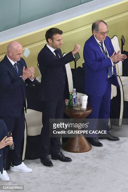 French President Emmanuel Macron gestures as he attends with FIFA President Gianni Infantino and the president of the French Football Federation,...