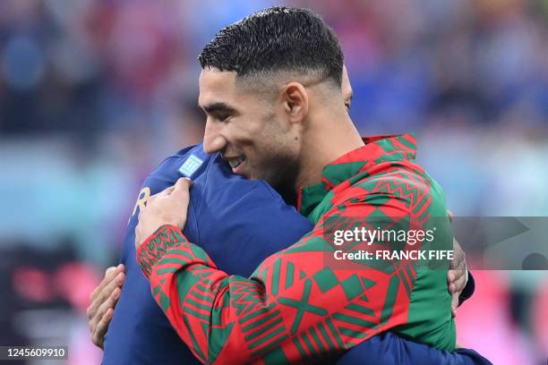 Morocco's defender Achraf Hakimi greets France's forward Kylian Mbappe at the start of the Qatar 2022 World Cup semi-final football match between...