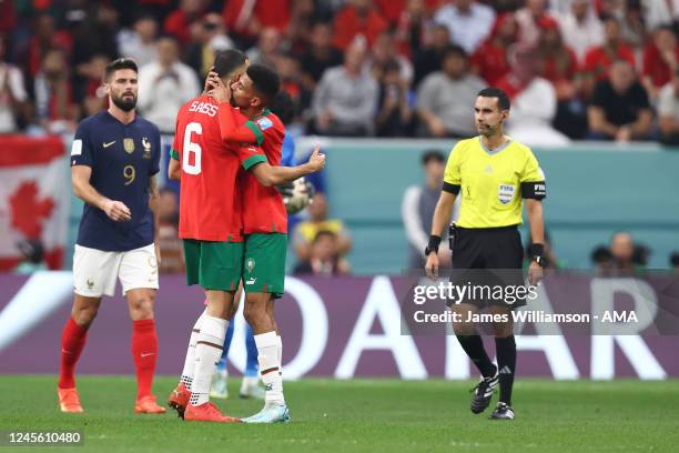 Romain Saiss of Morocco leaves the game in the first half with an injury and is kissed by Azzedine Ounahi of Morocco during the FIFA World Cup Qatar...