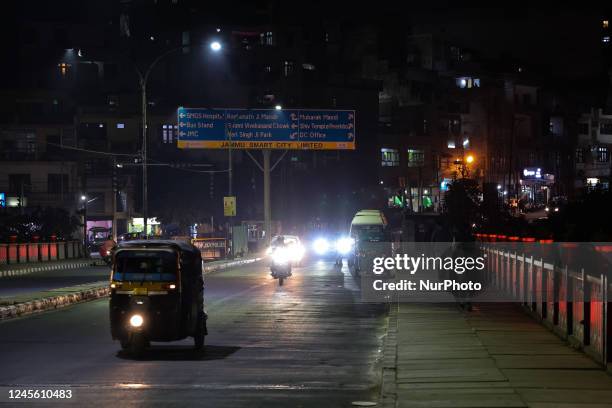 People walk as vehicles move over Tawi bridge during an evening in Jammu City Jammu and Kashmir India on 14 December 2022