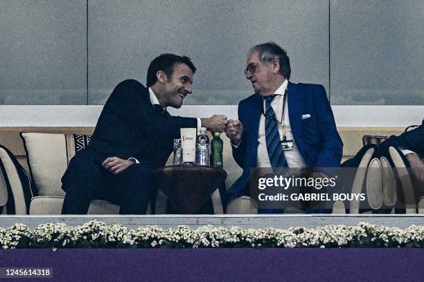 French President Emmanuel Macron bumps fists with the president of the French Football Federation, Noël Le Graët, after France's forward Randal Kolo...