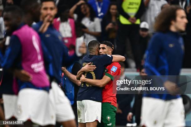 France's forward Kylian Mbappe and Morocco's defender Achraf Hakimi greet each other at the end of the Qatar 2022 World Cup semi-final football match...