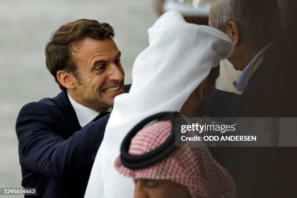 French President Emmanuel Macron celebrates after France won the Qatar 2022 World Cup semi-final football match between France and Morocco at the...