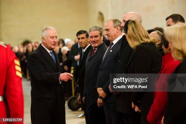 King Charles III speaks to Prime Minister Rishi Sunak and Labour leader Sir Kier Starmer at the Houses of Parliament where he saw a new plaque...