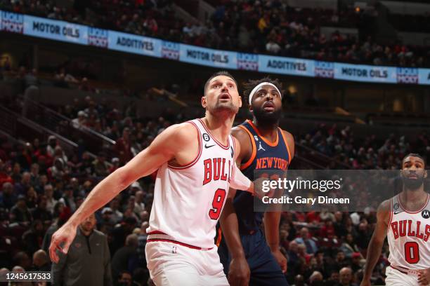 Nikola Vucevic of the Chicago Bulls plays defense on Mitchell Robinson of the New York Knicks during the game on December 14, 2022 at United Center...