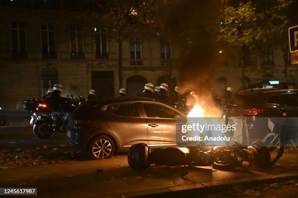 Fans clash with police as fans of France celebrate victory after France defeated Morocco in FIFA World Cup Qatar 2022 semi-final match in Paris,...