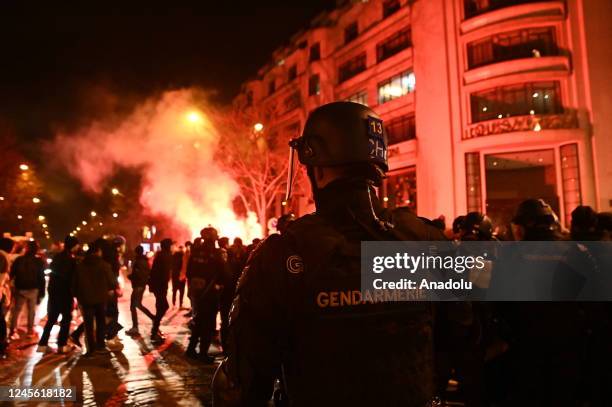 Fans clash with police as fans of France celebrate victory after France defeated Morocco in FIFA World Cup Qatar 2022 semi-final match in Paris,...