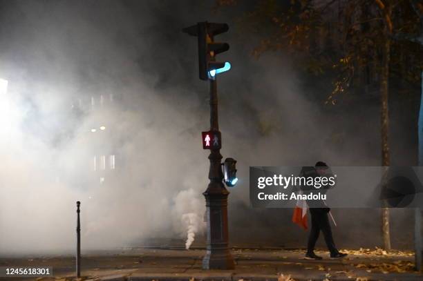 Fans clash with police as fans of France celebrate victory after France defeated Morocco in FIFA World Cup Qatar 2022 semi-final match in Paris,...