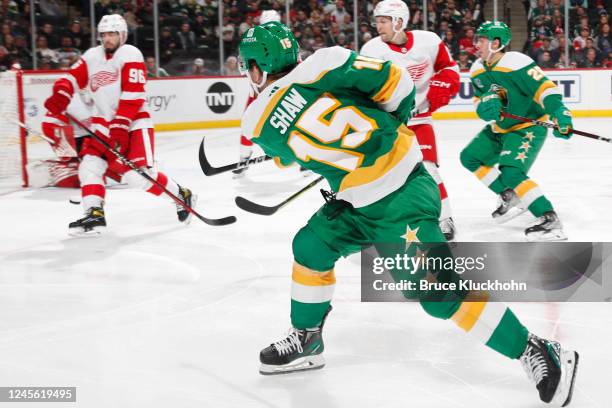 Mason Shaw of the Minnesota Wild shoots the puck with Jake Walman of the Detroit Red Wings defending during the game at the Xcel Energy Center on...