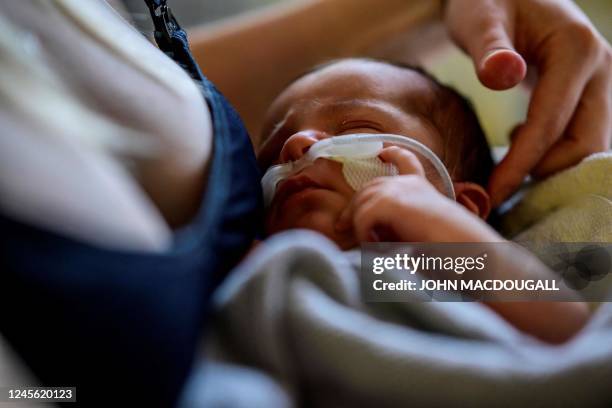 Day-old Andreas wears a respirator as he lies with his mother in an intensive care unit at the pediatric ward of Berlin's Saint Joseph Hospital on...