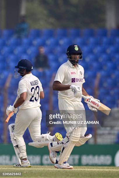 Indias Kuldeep Yadav and Ravichandran Ashwin run between the wickets during the second day of the first cricket Test match between Bangladesh and...