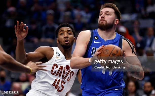 Luka Doncic of the Dallas Mavericks looks to pass against Donovan Mitchell of the Cleveland Cavaliers in the second half at American Airlines Center...