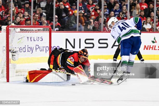 Calgary Flames Goalie Jacob Markstrom stops Vancouver Canucks Center Elias Pettersson during the shootout of an NHL game between the Calgary Flames...