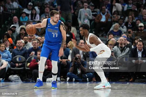 Luka Doncic of the Dallas Mavericks handles the ball while Donovan Mitchell of the Cleveland Cavaliers plays defense during the game on December 14,...
