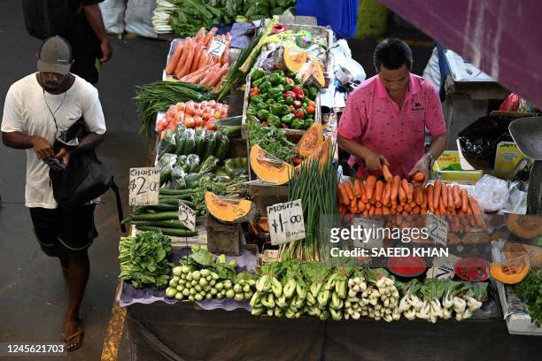 Vendor arranges vegetables at his stall inside the Suva Municipal Markets in downtown Suva on December 15, 2022.