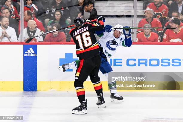 Calgary Flames Defenceman Nikita Zadorov bodychecks Vancouver Canucks Winger J.T. Miller during the first period of an NHL game between the Calgary...