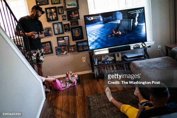 Derron Reed with his 10-year-old son Ezra and his 4-year-old daughter Kendall at home in Thornton, Colorado, Thursday, September 29, 2022. One of the...
