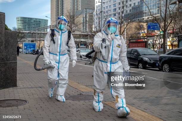Workers wearing protective gear in Beijing, China, on Thursday, Dec. 15, 2022. China's economic activity worsened in November before the government...